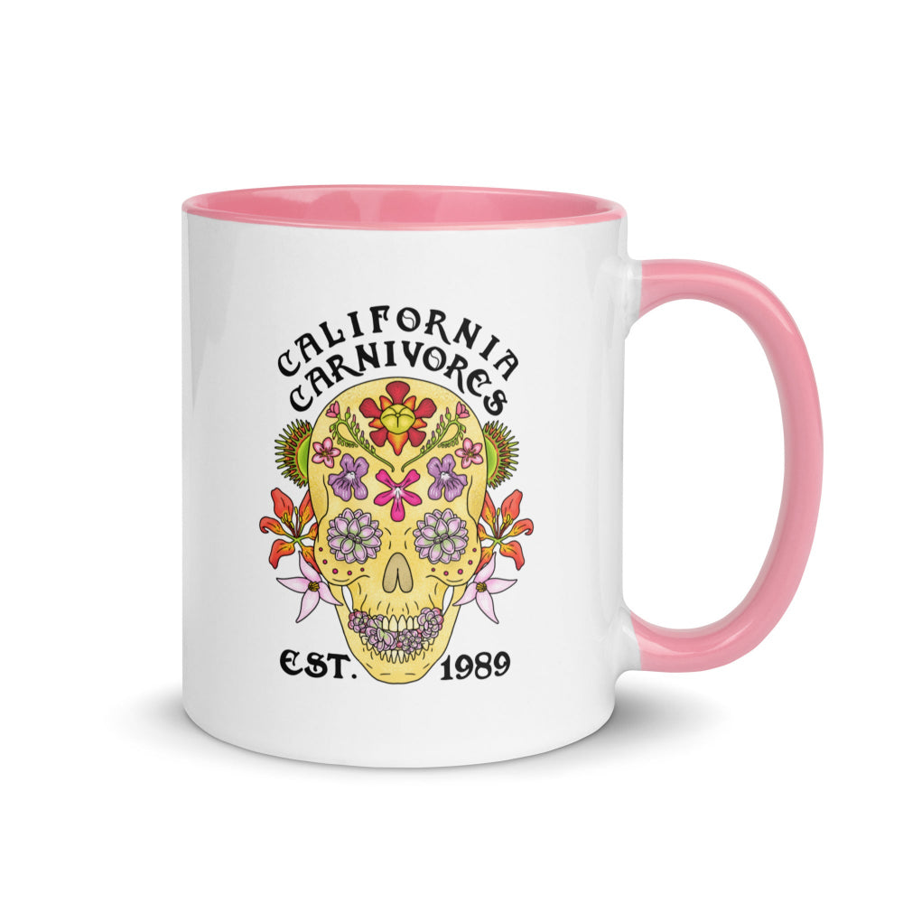 Mug with floral skull design and 'California Carnivores' text on a white background