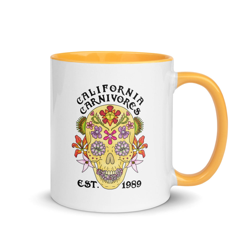 Mug with floral skull design and 'California Carnivores' text on a white background